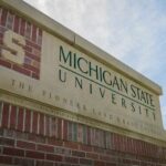Sign for Michigan State University with a blue sky in the background