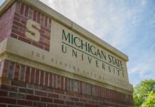 Sign for Michigan State University with a blue sky in the background