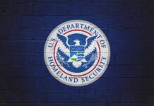 DHS Power Grab Targets Immigration Lawyers Logo of the U.S. Department of Homeland Security on a blue wall