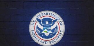 DHS Power Grab Targets Immigration Lawyers Logo of the U.S. Department of Homeland Security on a blue wall