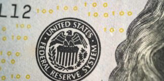 Close-up of a United States dollar bill featuring the Federal Reserve System seal