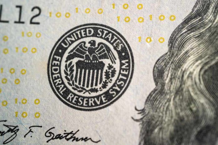 Close-up of a United States dollar bill featuring the Federal Reserve System seal