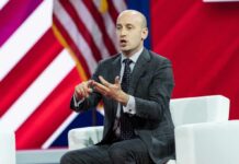 Viral Exchange Sends Democrats Fuming A man in a suit speaking passionately at a conference panel