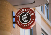 Chipotle Mexican Grill sign mounted on a brick wall
