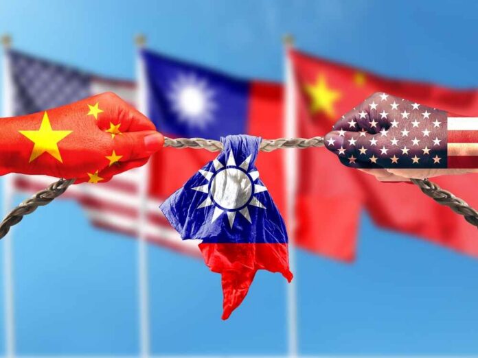shutterstock_2307742711.jpg Hands painted with flags of China and the USA pulling a torn Taiwan flag