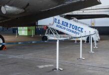 U.S. Air Force boarding stairs next to a military aircraft in an airport hangar