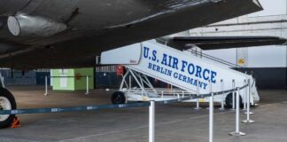 U.S. Air Force boarding stairs next to a military aircraft in an airport hangar