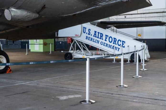 U.S. Air Force boarding stairs next to a military aircraft in an airport hangar