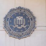 FBI seal mounted on a wall, representing the Federal Bureau of Investigation
