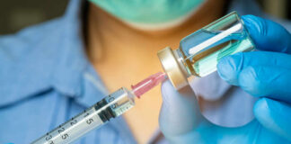 Rebel Zones Fuel Ebola Chaos in Congo Healthcare professional preparing a syringe from a vial