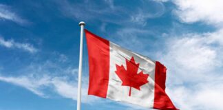 China’s Secretive Canada Deal Sparks Fears Canadian flag waving against a blue sky