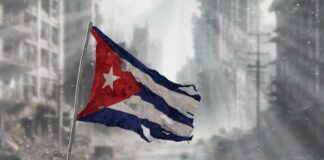 US-Cuba Tensions Soar—What’s At Stake? Tattered Cuban flag waving over a pile of rubble in a devastated urban landscape