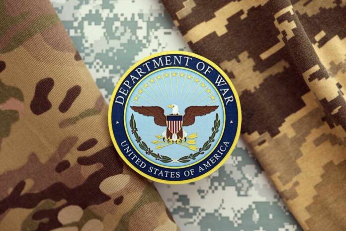 shutterstock_2694337805.jpg Department of War emblem on camouflage fabric