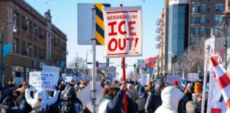 Riot Chaos Silences Press In Newark Crowd of protesters holding signs at a rally against ICE