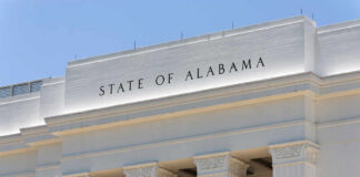 Facade of a government building with the words 'STATE OF ALABAMA' displayed prominently