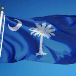 South Carolina state flag waving against a blue sky