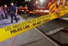 Massive LA Fire Still Burning Police tape cordons off a nighttime street scene