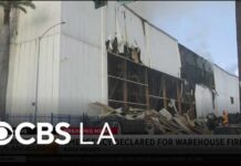 Smoke continues to grow Sunday morning from the Boyle Heights warehouse fire