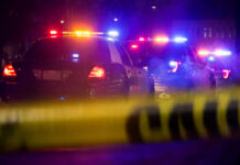 Highway Heroes Beat Flames To Survivors Police cars with flashing lights at a nighttime scene behind crime scene tape