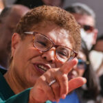 A political figure passionately speaking to a crowd with an expressive gesture