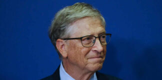 Capitol Shock: Gates Called Into Epstein Review A business leader with glasses smiling in front of a blue background