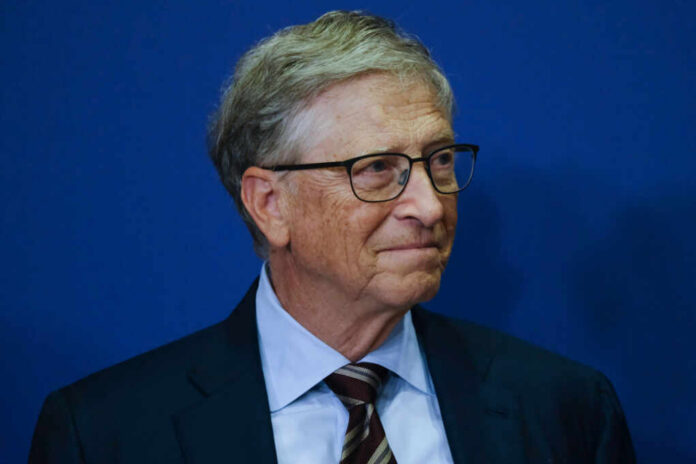 A business leader with glasses smiling in front of a blue background
