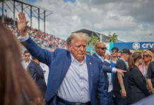 Foreign Leaders Scramble For Trump’s Octagon A public figure waving to a crowd at an outdoor event