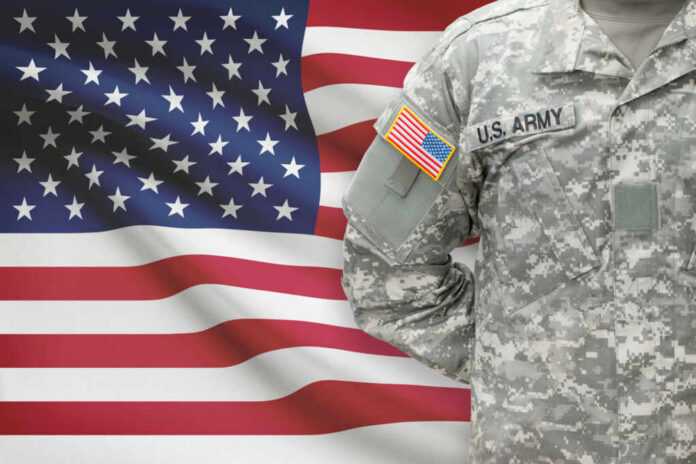 shutterstock247938520jpg U.S. Army soldiers uniform with American flag in the background