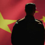 Silhouette of a soldier in front of the Chinese flag