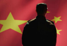 Beijing’s Inside Man Pleads Guilty Silhouette of a soldier in front of the Chinese flag