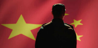 Beijing’s Inside Man Pleads Guilty Silhouette of a soldier in front of the Chinese flag