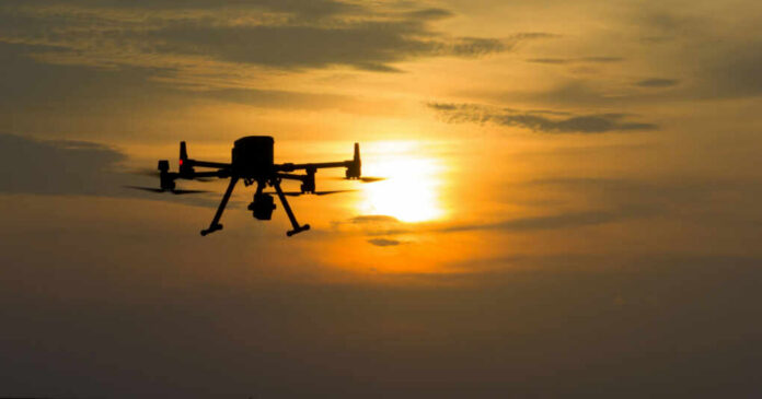 shutterstock2506644171jpg A silhouette of a drone flying against a sunset sky