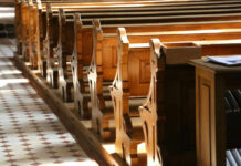 Sacred Landmark, Sudden Bidding War Interior of a church featuring wooden pews and natural light streaming in