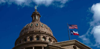 Texas Shock: Convicted Fraudster Runs Again The dome of a state capitol building with flags flying against a blue sky