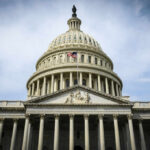 The U.S. Capitol building with an American flag flying in front