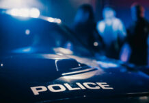 Close-up of a police car with emergency lights in a blurred background