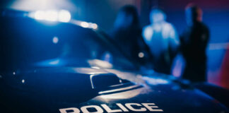 Close-up of a police car with emergency lights in a blurred background