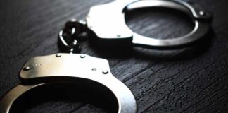 Actor In Custody β Case Keeps Growing Close-up of metallic handcuffs on a textured surface