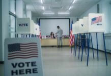 States Cornered: Security Funds On The Line Interior of a polling station with voting booths and officials