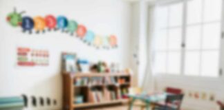 A bright and colorful children's room with a bookshelf and a play table