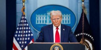 Iran Missiles Fly—Trump Says Hold Fire A political figure at a podium during a press conference in front of the White House