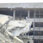 Damaged building structure with exposed debris and scaffolding