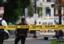 Teen Crossfire Erupts In Packed Mall Police officers near a crime scene marked by caution tape