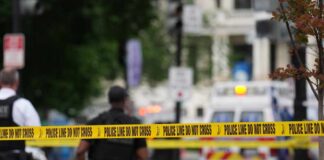 Teen Crossfire Erupts In Packed Mall Police officers near a crime scene marked by caution tape