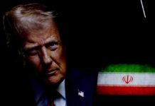 Close-up portrait of a political figure with the Iranian flag in the background