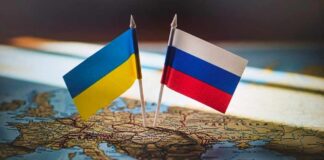 Peace Offer? Read Putin’s Fine Print Ukrainian and Russian flags pinned on a map of Eastern Europe