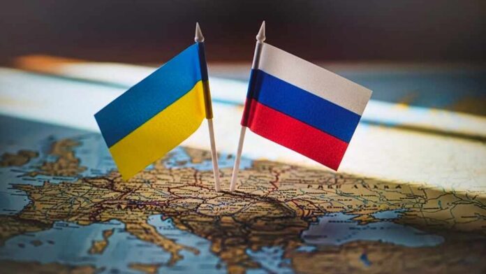 Ukrainian and Russian flags pinned on a map of Eastern Europe