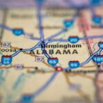 Close-up of a road map highlighting Alabama and nearby cities
