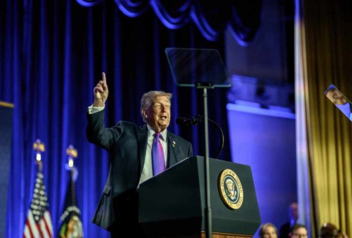 A speaker at a podium gesturing during a political event