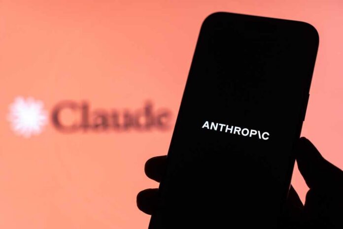Anthropic,Logo,Is,Displayed,On,The,Screen,Of,A,Smartphone, A hand holding a smartphone displaying the word 'ANTHROPIC' against a blurred background